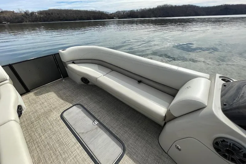 Slide: The Image of 2023 Cypress Cay Seabreeze 252 pontoon boat interior with comfortable seating and scenic lake view. - 14