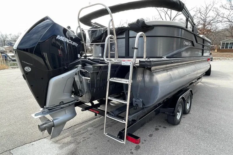 Slide: The Image of 2023 Cypress Cay Seabreeze 252 pontoon boat with Mercury Verado engine on trailer. - 2