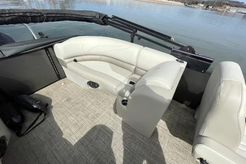 Slide: The Image of 2023 Cypress Cay Seabreeze 252 pontoon boat interior with beige seating and lake view. - 8