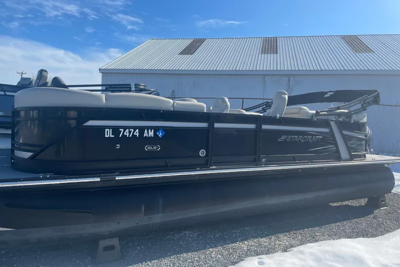The Image of 2020 Starcraft SLS 3 pontoon boat parked outdoors on gravel. - 1