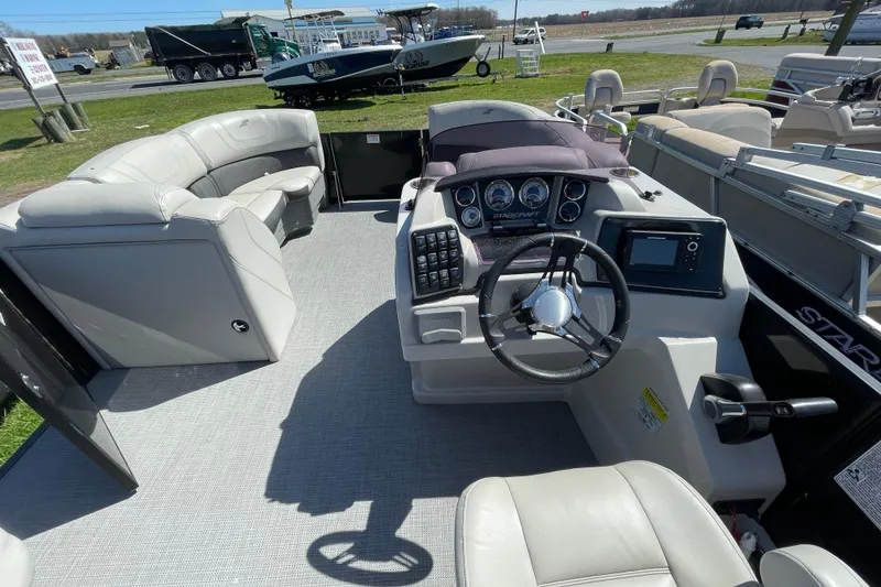 Slide: The Image of 2020 Starcraft SLS 3 boat interior with steering console and seating area. - 10