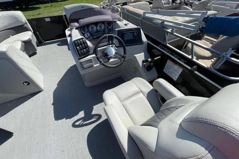 Slide: The Image of Interior view of a 2020 Starcraft SLS 3 boat cockpit with steering wheel and controls. - 11