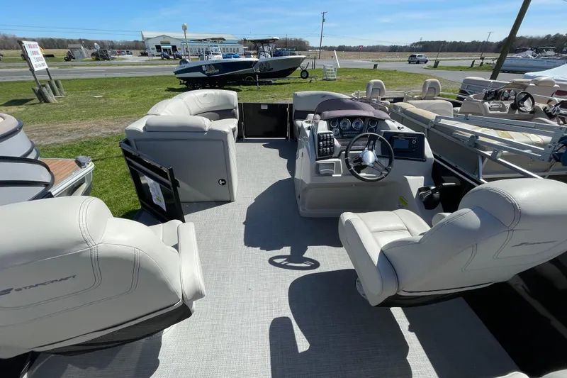 Slide: The Image of 2020 Starcraft SLS 3 pontoon boat interior with plush seating and modern dashboard. - 3