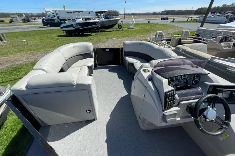 Slide: The Image of 2020 Starcraft SLS 3 pontoon boat interior with plush seating and modern dashboard. - 6
