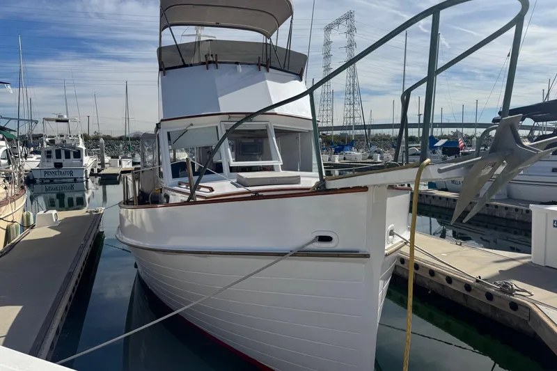 The Image of 1966 Grand Banks 32 Sedan docked at a marina, showcasing classic design. - 0