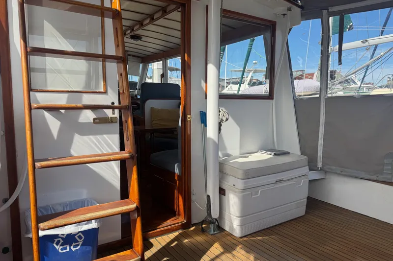 Slide: The Image of 1966 Grand Banks 32 Sedan interior with wooden ladder and seating area. - 16