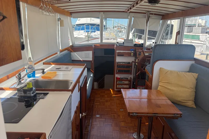 Slide: The Image of Interior of a 1966 Grand Banks 32 Sedan with kitchen and seating area. - 17