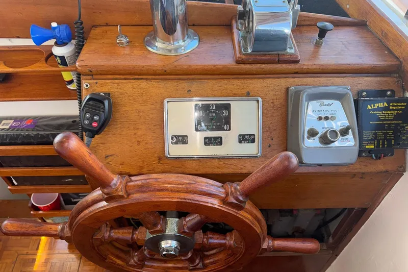 Slide: The Image of Wooden helm of a 1966 Grand Banks 32 Sedan with vintage controls and instruments. - 20