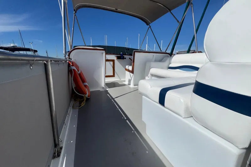 Slide: The Image of 1966 Grand Banks 32 Sedan boat interior with white seating and life preserver. - 25