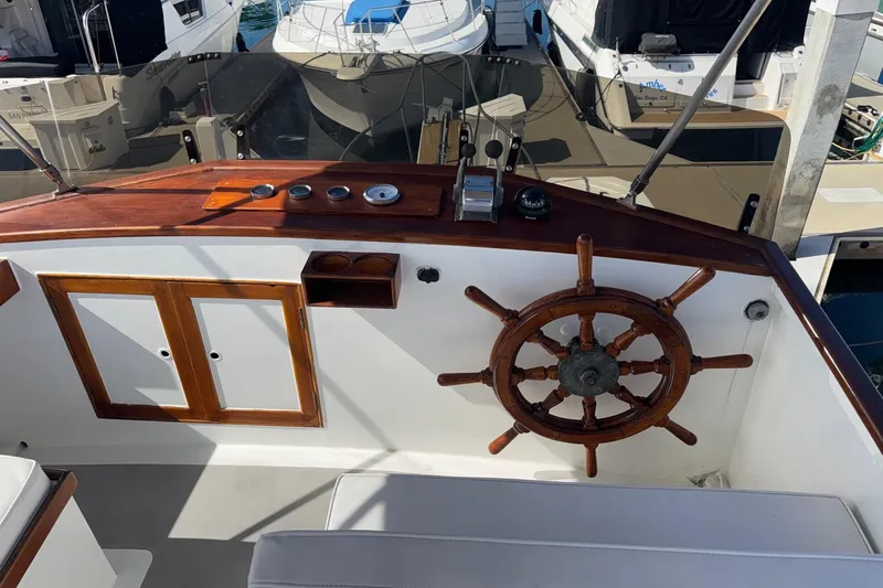 Slide: The Image of 1966 Grand Banks 32 Sedan helm with wooden wheel and control panel. - 28