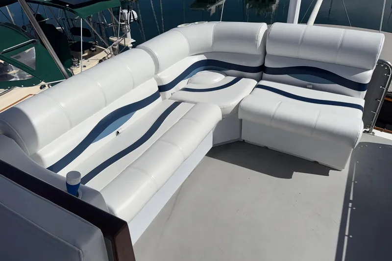 Slide: The Image of 1966 Grand Banks 32 Sedan with white and blue cushioned seating on deck. - 31