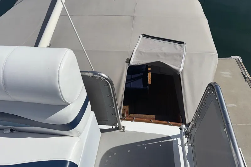 Slide: The Image of 1966 Grand Banks 32 Sedan boat with open hatch and cushioned seating. - 33