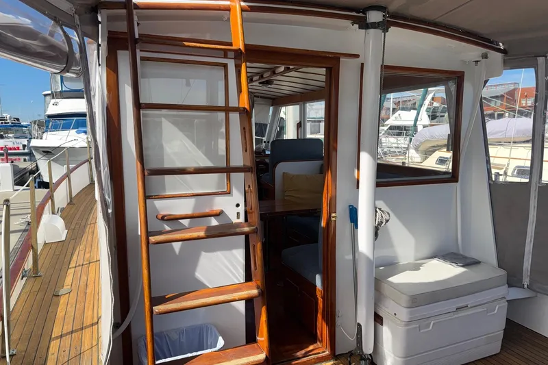 Slide: The Image of 1966 Grand Banks 32 Sedan boat interior with wooden ladder and seating area. - 34