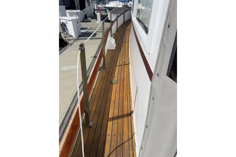 Slide: The Image of 1966 Grand Banks 32 Sedan teak deck with railing, docked at marina. - 35