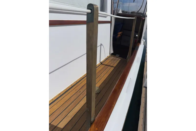 Slide: The Image of 1966 Grand Banks 32 Sedan boat deck with wooden railing and walkway. - 37