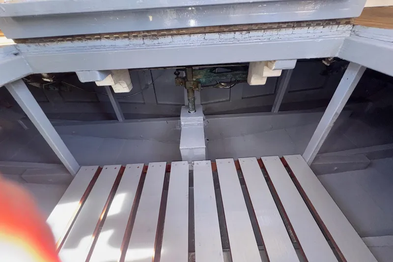 Slide: The Image of Interior view of a 1966 Grand Banks 32 Sedan boat, showcasing wooden slats and structural details. - 42