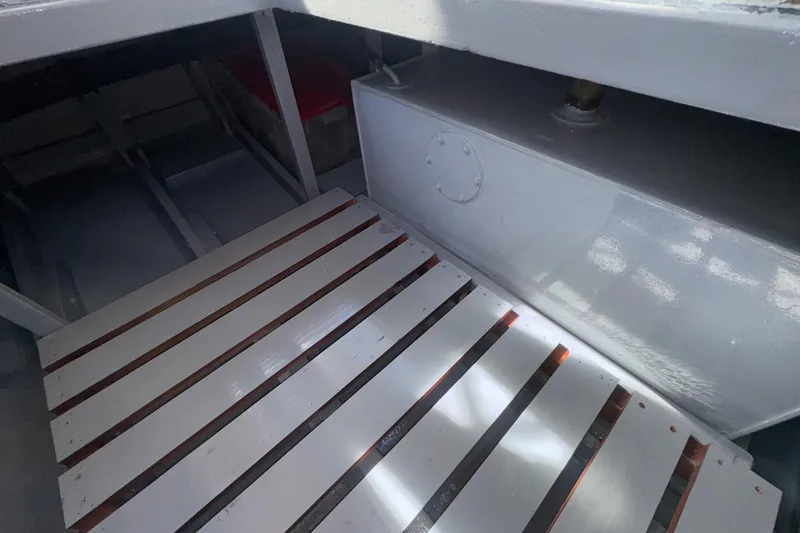 Slide: The Image of 1966 Grand Banks 32 Sedan interior with wooden slats and storage compartment. - 43