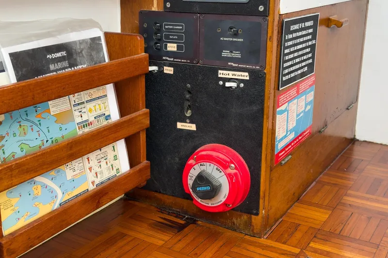 Slide: The Image of Electrical panel and navigation charts on a 1966 Grand Banks 32 Sedan boat. - 51