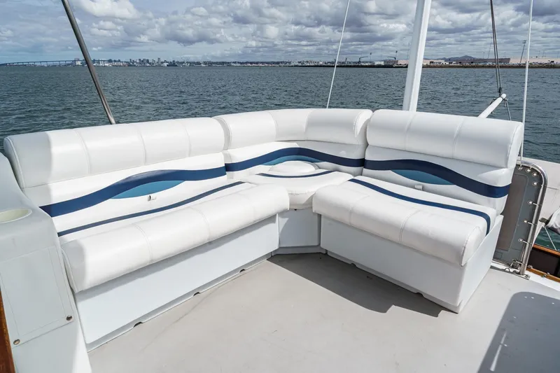 Slide: The Image of White and blue seating on a 1966 Grand Banks 32 Sedan boat, overlooking the ocean. - 56