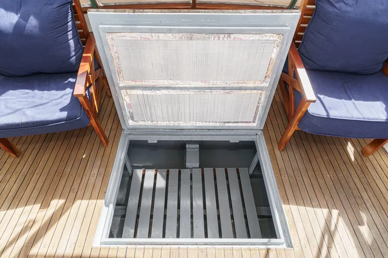 Slide: The Image of Open hatch on 1966 Grand Banks 32 Sedan boat deck with wooden chairs. - 58