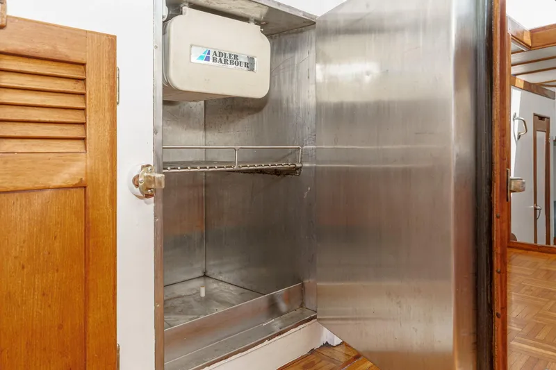 Slide: The Image of Open stainless steel refrigerator inside 1966 Grand Banks 32 Sedan boat. - 63