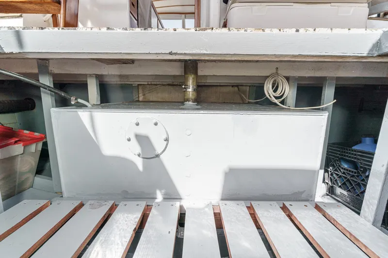 Slide: The Image of 1966 Grand Banks 32 Sedan interior showing storage compartment and equipment. - 65