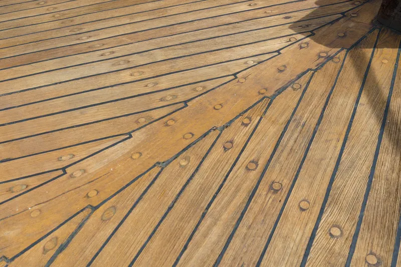 Slide: The Image of Teak deck of a 1966 Grand Banks 32 Sedan boat, showcasing detailed woodwork. - 67