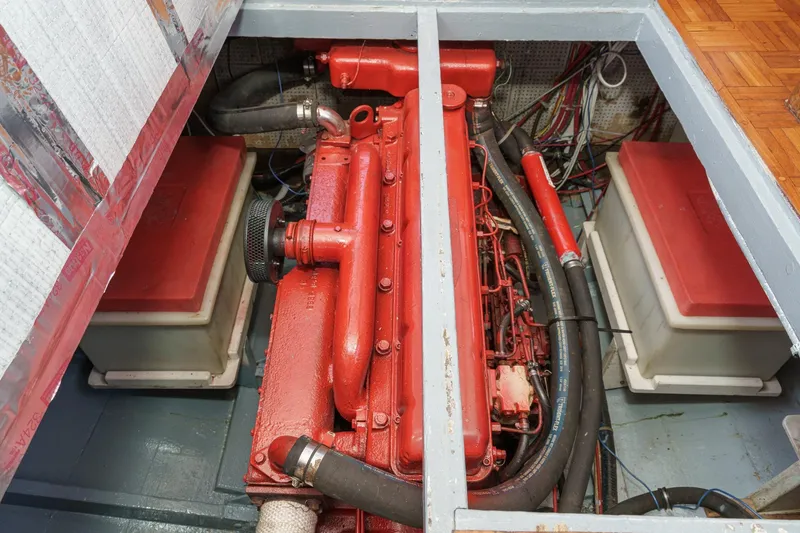 Slide: The Image of Engine compartment of a 1966 Grand Banks 32 Sedan with red-painted engine components. - 76
