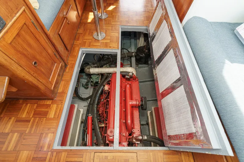 Slide: The Image of Engine compartment of a 1966 Grand Banks 32 Sedan with parquet flooring and wooden cabinetry. - 77