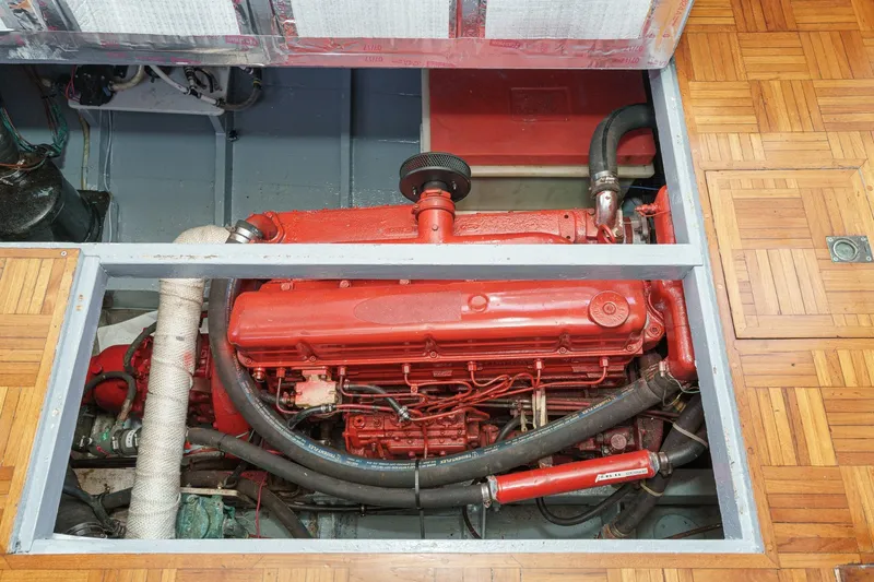 Slide: The Image of Engine compartment of a 1966 Grand Banks 32 Sedan, featuring a red marine engine. - 79