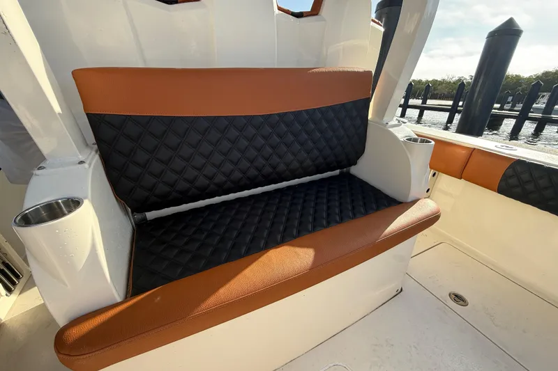 Slide: The Image of Luxurious seating on 2019 Scout 355 LXF boat with quilted upholstery and cup holders. - 20