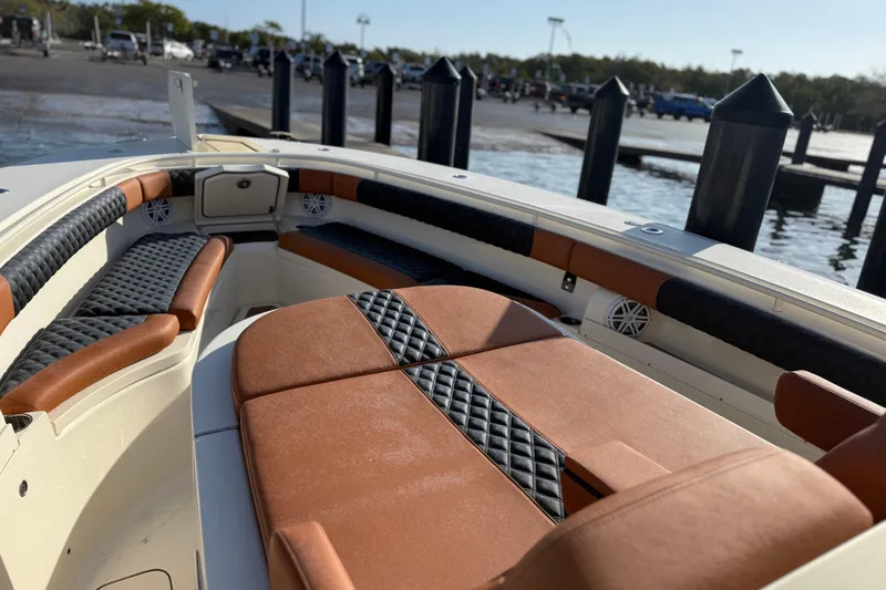 Slide: The Image of 2019 Scout 355 LXF boat interior with luxurious seating and waterfront view. - 22