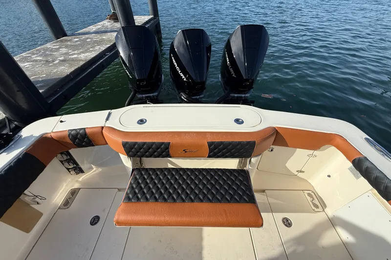 Slide: The Image of 2019 Scout 355 LXF boat with triple Mercury engines at dock. - 28