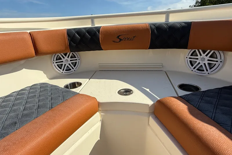 Slide: The Image of 2019 Scout 355 LXF boat interior with cushioned seating and speakers. - 29