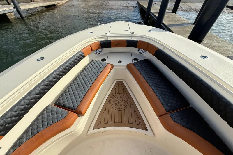 Slide: The Image of 2019 Scout 355 LXF boat interior with luxurious seating and wood accents. - 30