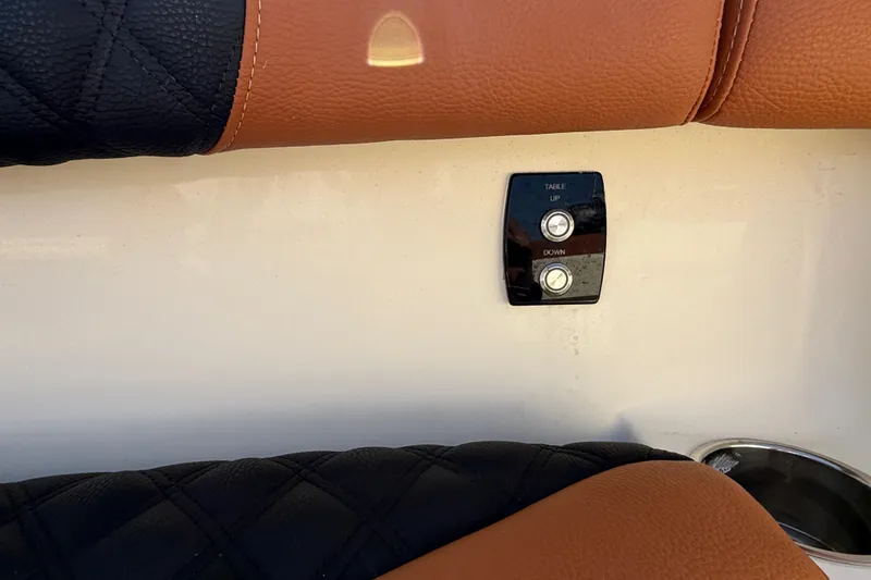 Slide: The Image of 2019 Scout 355 LXF boat interior with table control buttons and leather seating. - 31