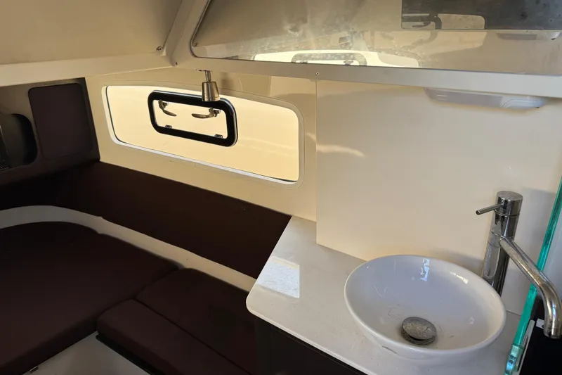 Slide: The Image of 2019 Scout 355 LXF boat interior with sink and seating area. - 35