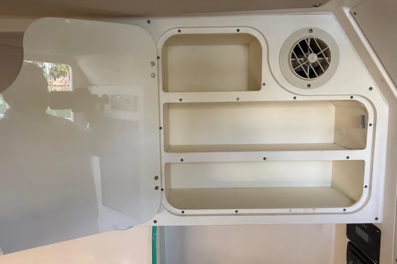 Slide: The Image of Interior storage shelves with vent in 2019 Scout 355 LXF boat. - 36