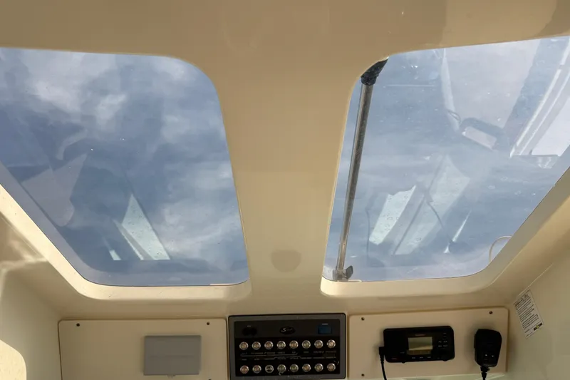 Slide: The Image of Interior view of 2019 Scout 355 LXF boat, featuring skylights and control panel. - 39