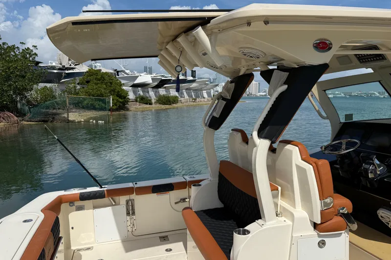 Slide: The Image of 2019 Scout 355 LXF boat interior with seating and water view. - 42