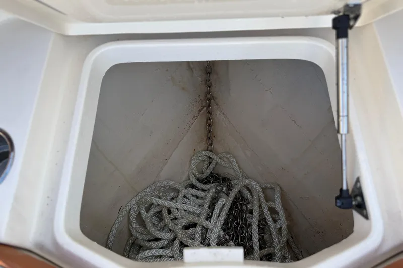 Slide: The Image of Anchor storage compartment on a 2019 Scout 355 LXF boat with rope and chain. - 47