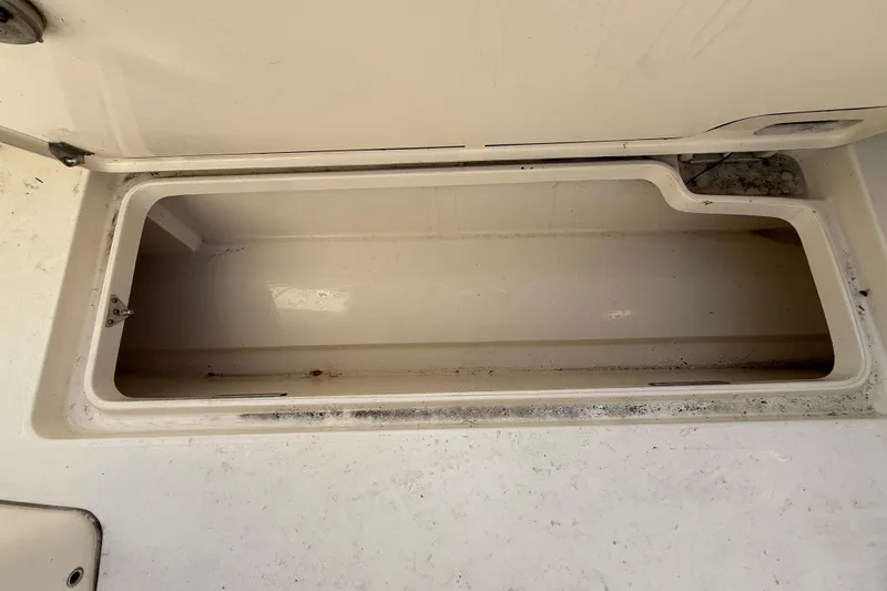 Slide: The Image of Open storage compartment on a 2019 Scout 355 LXF boat. - 49