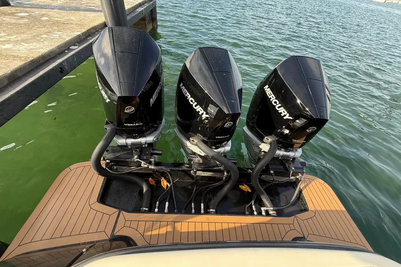 Slide: The Image of 2019 Scout 355 LXF with triple Mercury outboard engines at dock. - 56