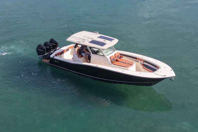 Slide: The Image of Scout 355 LXF 2019 boat on calm water. - 6