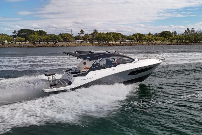 Slide: The Image of 2026 Granfort 37 boat cruising on a scenic waterway with lush greenery. - 3