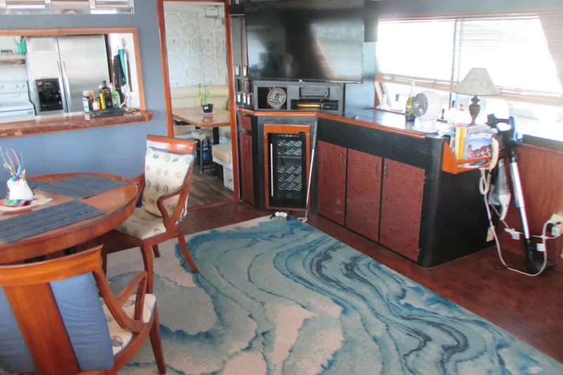 Slide: The Image of Interior of 1981 Hatteras 61 Motor Yacht with dining area and modern amenities. - 11