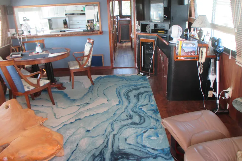 Slide: The Image of Interior of 1981 Hatteras 61 Motor Yacht with elegant decor and blue patterned rug. - 12