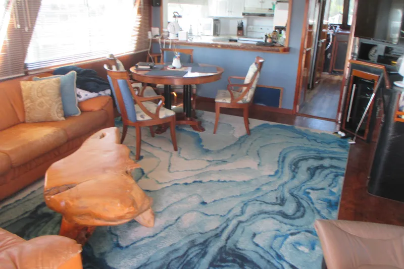 Slide: The Image of Interior of 1981 Hatteras 61 Motor Yacht with elegant furnishings and blue patterned rug. - 13