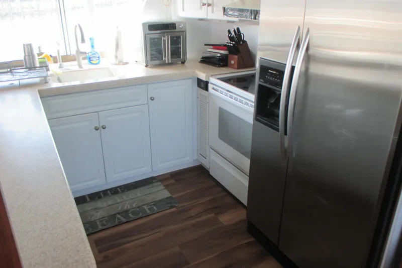 Slide: The Image of Kitchen interior of 1981 Hatteras 61 Motor Yacht with modern appliances and wood flooring. - 16