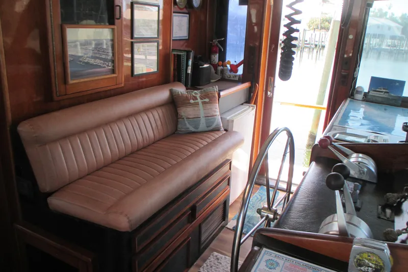 Slide: The Image of Interior of 1981 Hatteras 61 Motor Yacht with leather seating and nautical decor. - 20